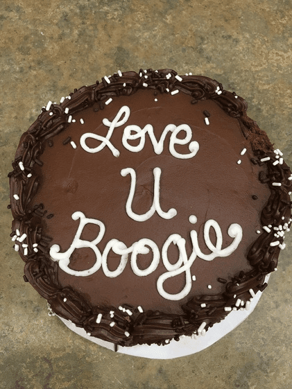 chocolate cake that says "love u boogie" on top