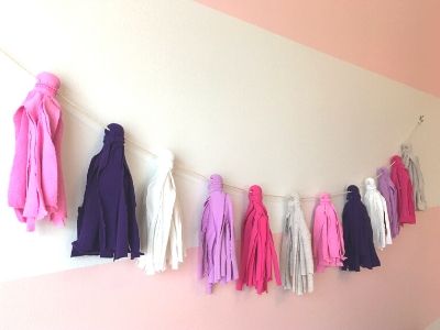 multicolored fabric tassel garland hanging on a wall