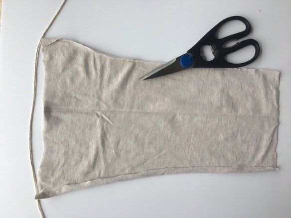 cream piece of fabric with scissors on top