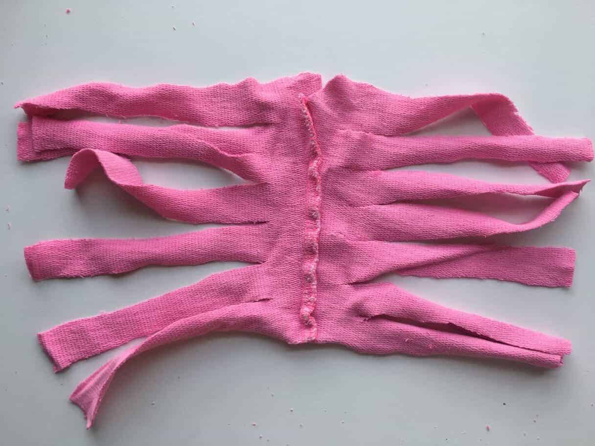 one half of pink shorts cut into strips