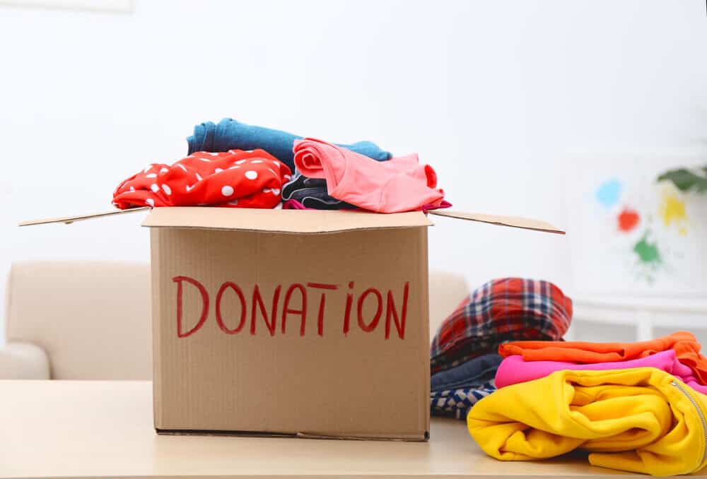 old clothes in a box that says donation