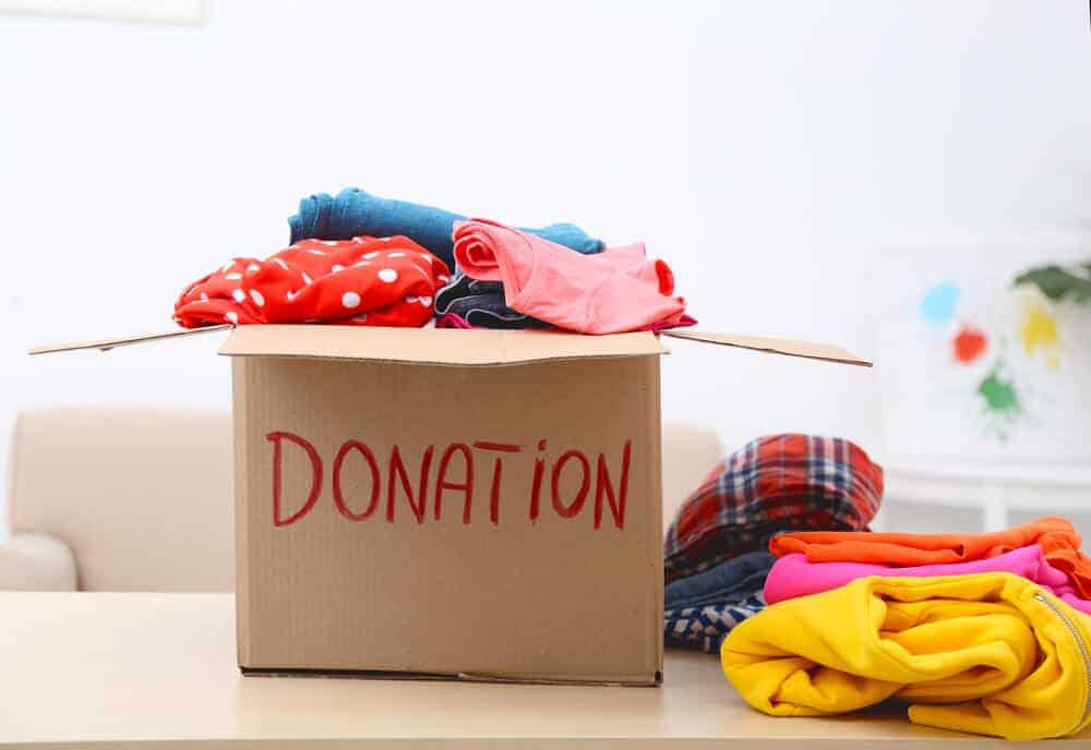 old clothes in a box that says donation