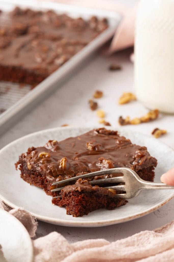 cutting into Texas chocolate sheet cake
