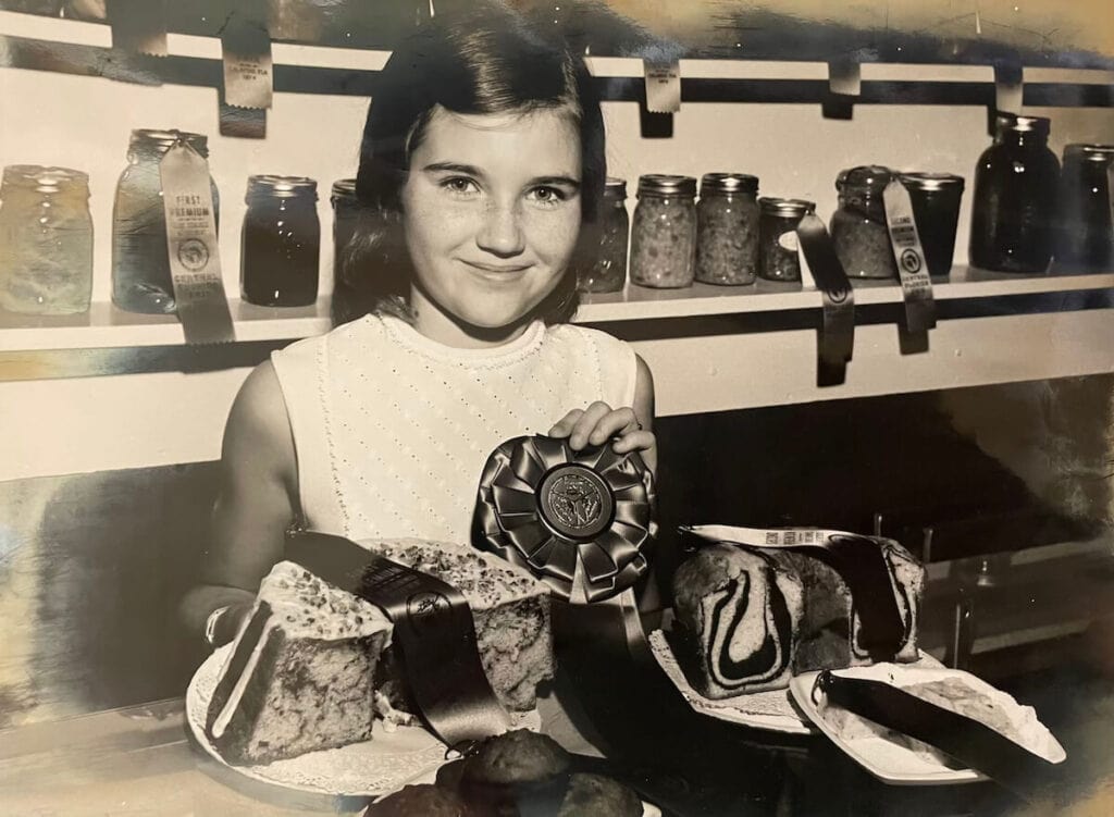 photo from 1970 with a girl with a blue ribbon and homemade cakes