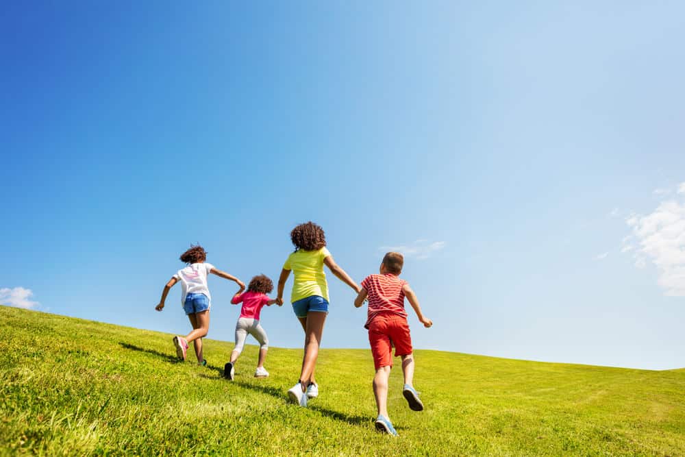 four kind kids playing outside