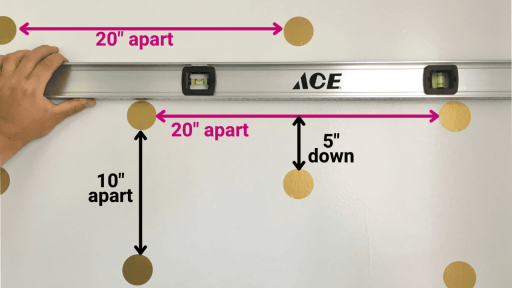 level and measurements for sticking polka dot wall decals to a wall
