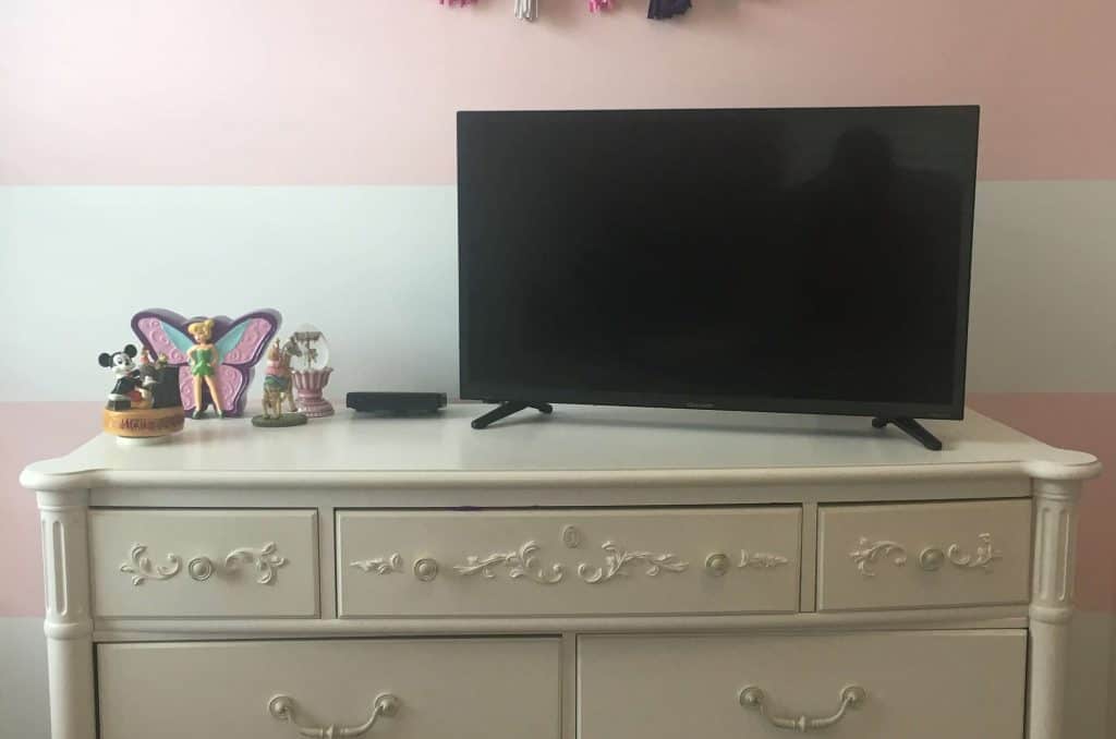 white dresser in a girls room with DIY garland hanging on the wall