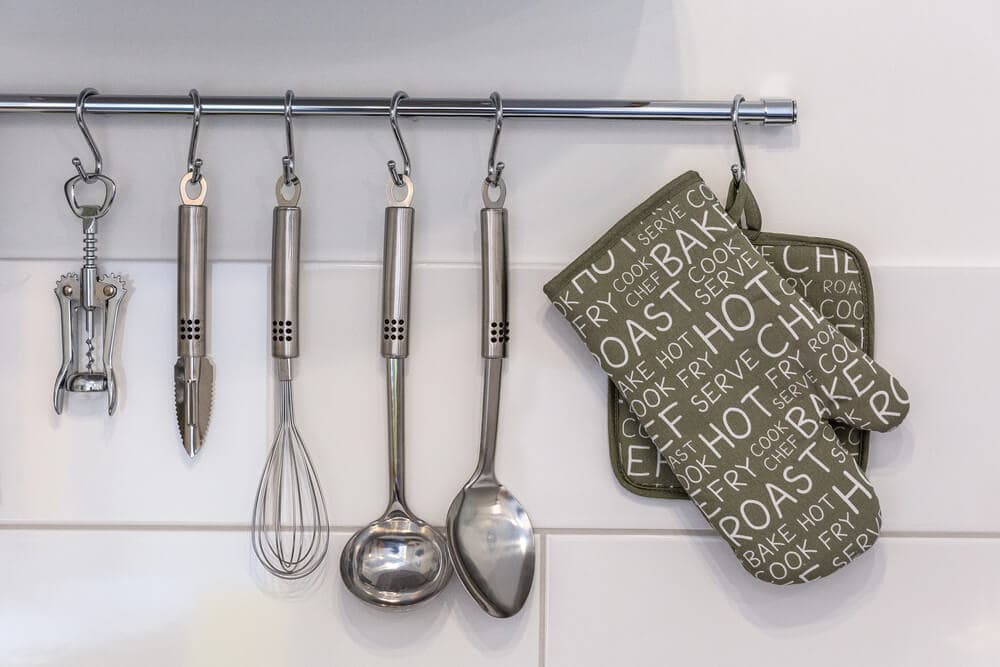 cooking utensils hanging on a towel bar