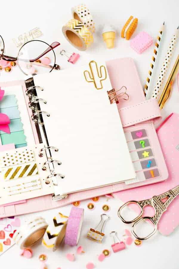 open planner on a desk with colorful planner accessories