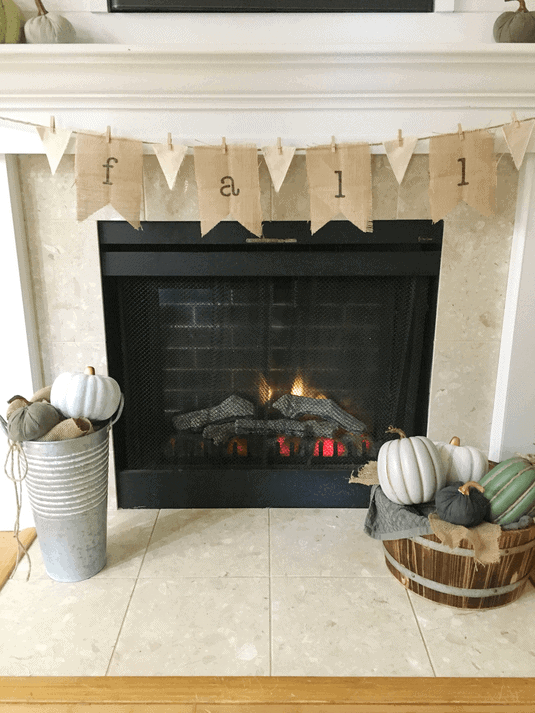 DIY burlap banner that says fall hung on a fireplace mantel