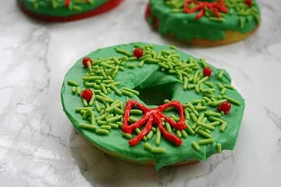 chocolate dipped apple slices decorated like Christmas wreaths