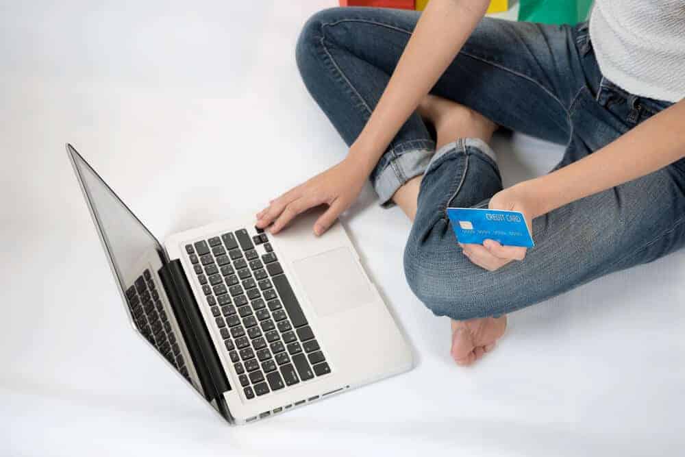 lady online shopping with credit card in hand