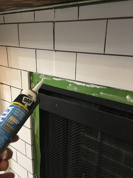 Want to know how to paint fireplace tile to look like subway tile? Try this tutorial to paint tile on your fireplace and transform it from boring builder grade tile to faux subway tile without a stencil!