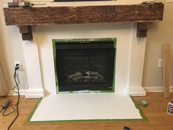 Want to know how to paint fireplace tile to look like subway tile? Try this tutorial to paint tile on your fireplace and transform it from boring builder grade tile to faux subway tile without a stencil!