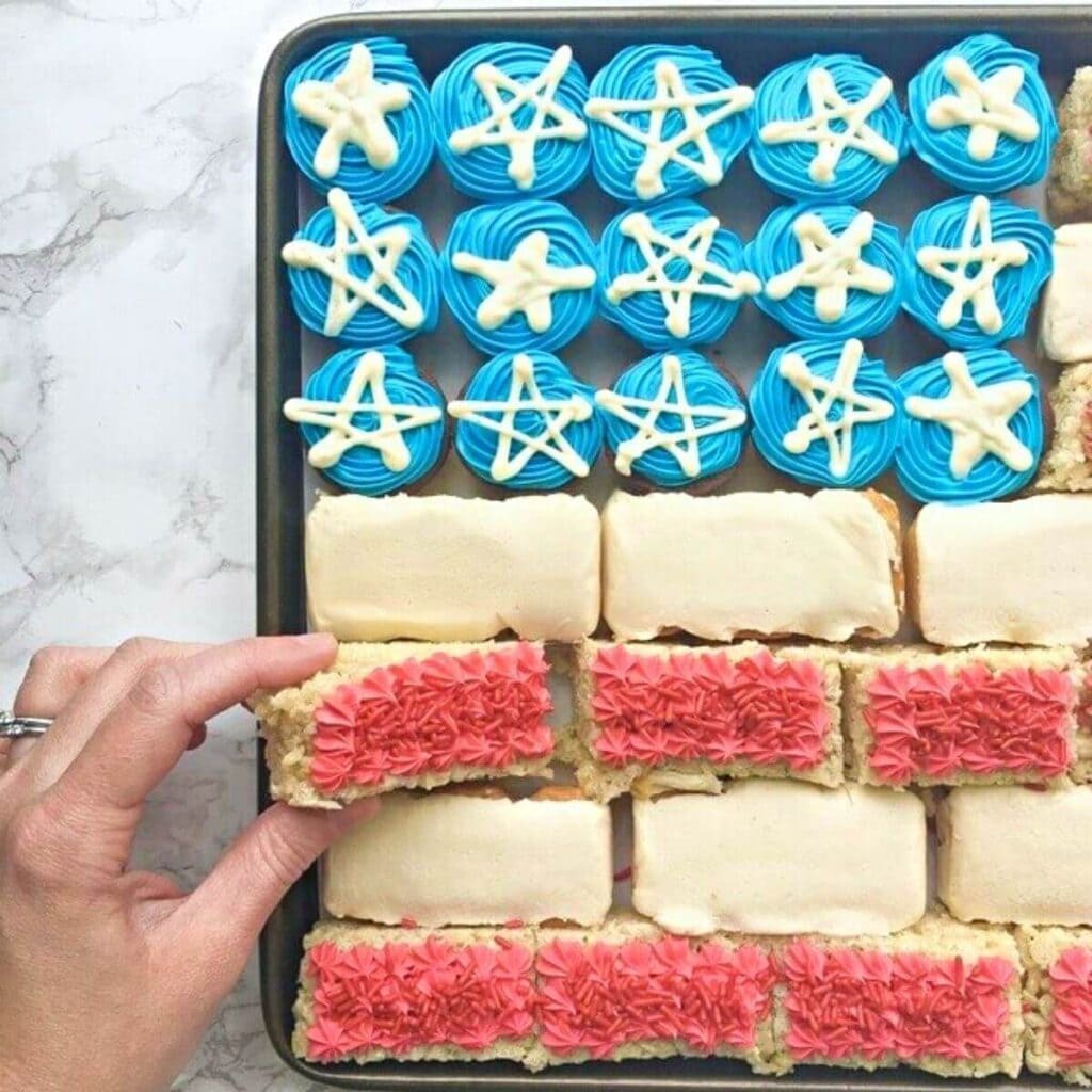 woman's hand picking up a piece of no bake flag cake