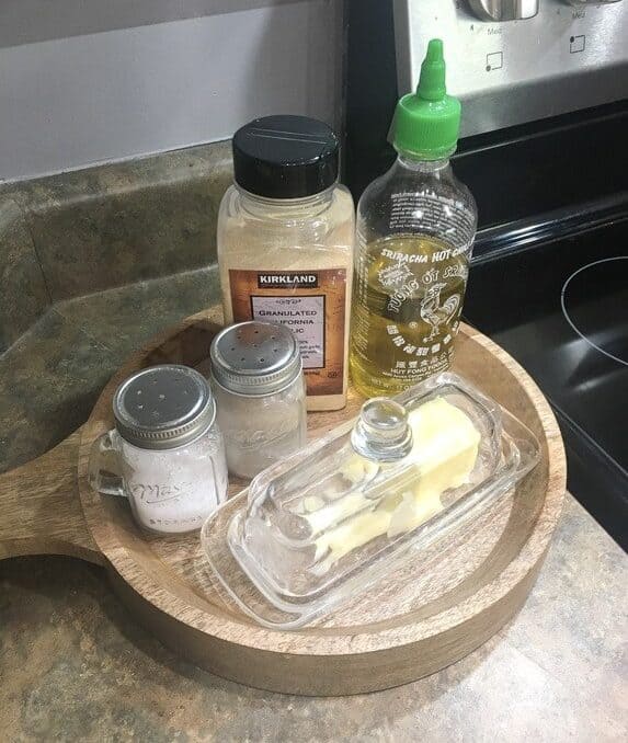 salt, pepper, and butter dish on a tray on the countertop