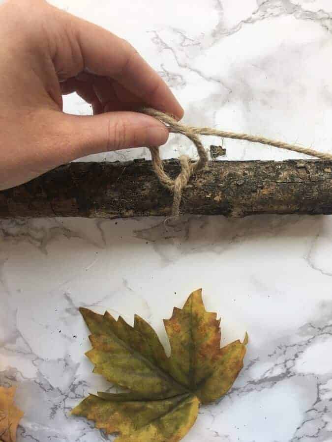 how to make an easy DIY wall hanging with a stick and fall leaves