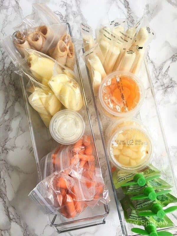 lunch box items organized into plastic bins