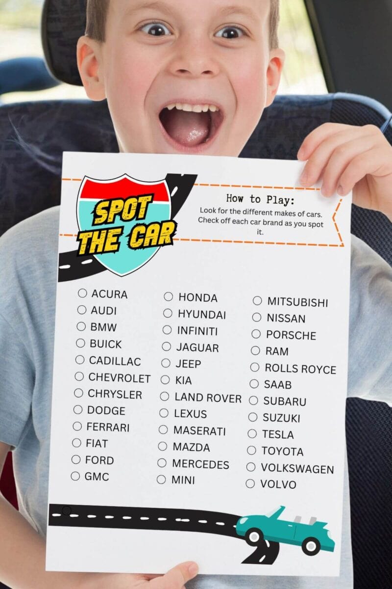boy in the back seat of a car holding up an activity sheet that says spot the car