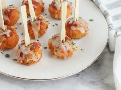 chicken parmesan bites with cocktail forks on a plate