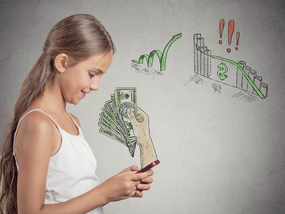 teen girl looking at a cell phone with money symbols in the background