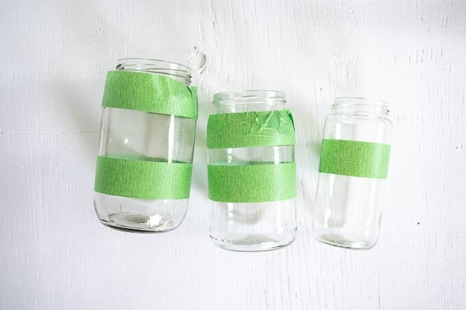 3 mason jars with green painter's tape stripes around them