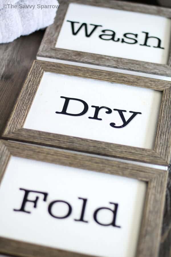 wash dry fold signs laying on a table