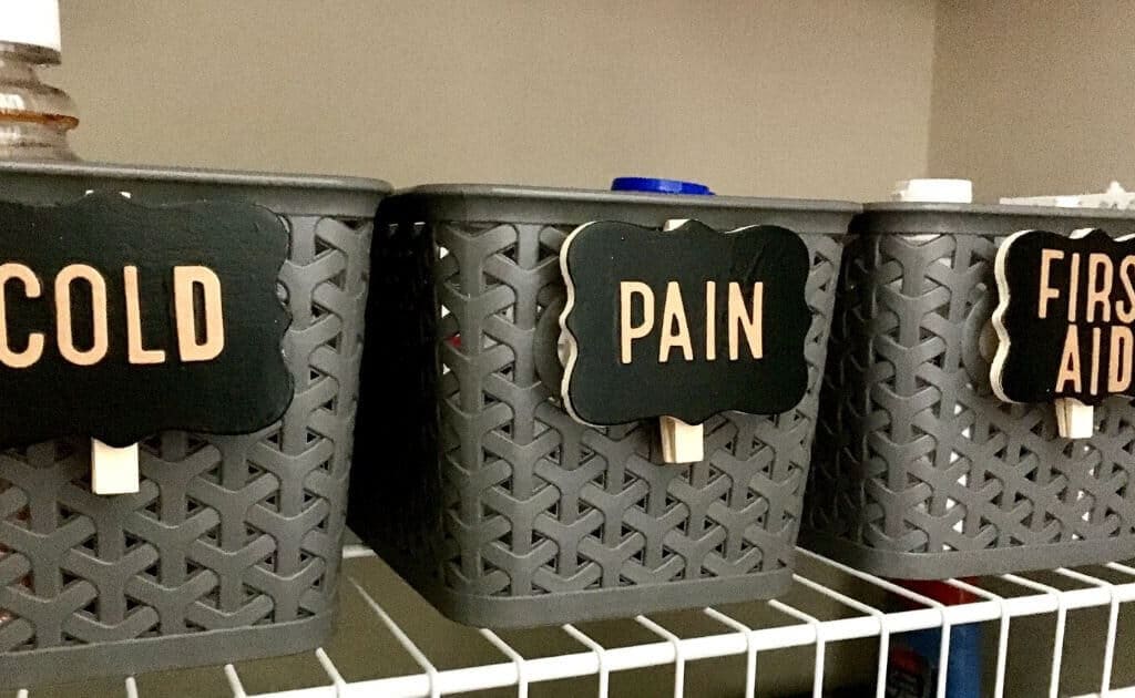 labeled storage baskets of medicine and first aid supplies