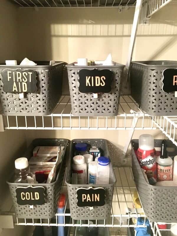 medicines and first aid supplies organized in labeled baskets