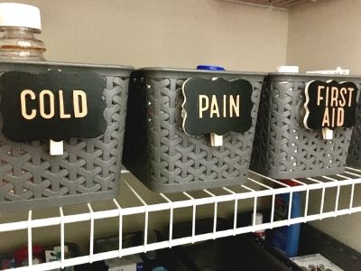 labeled storage baskets of medicine and first aid supplies