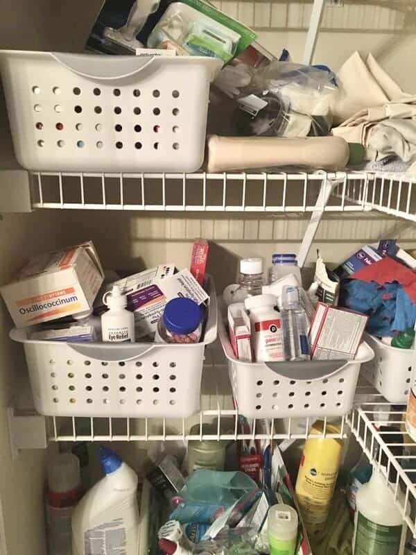 disorganized baskets of medicine in a small closet