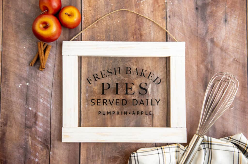 DIY Fall sign on a table with apples and a whisk