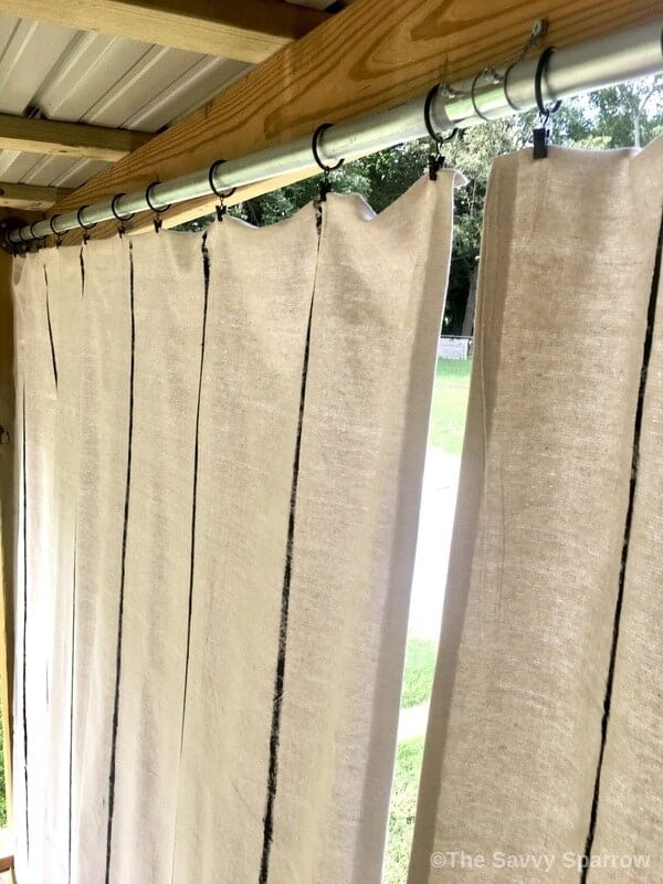 top of drop cloth curtains hung up with curtain clips