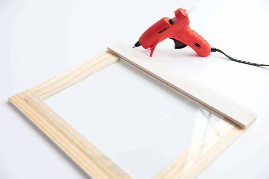 paint sticks and glass hot glued together to make a wood frame