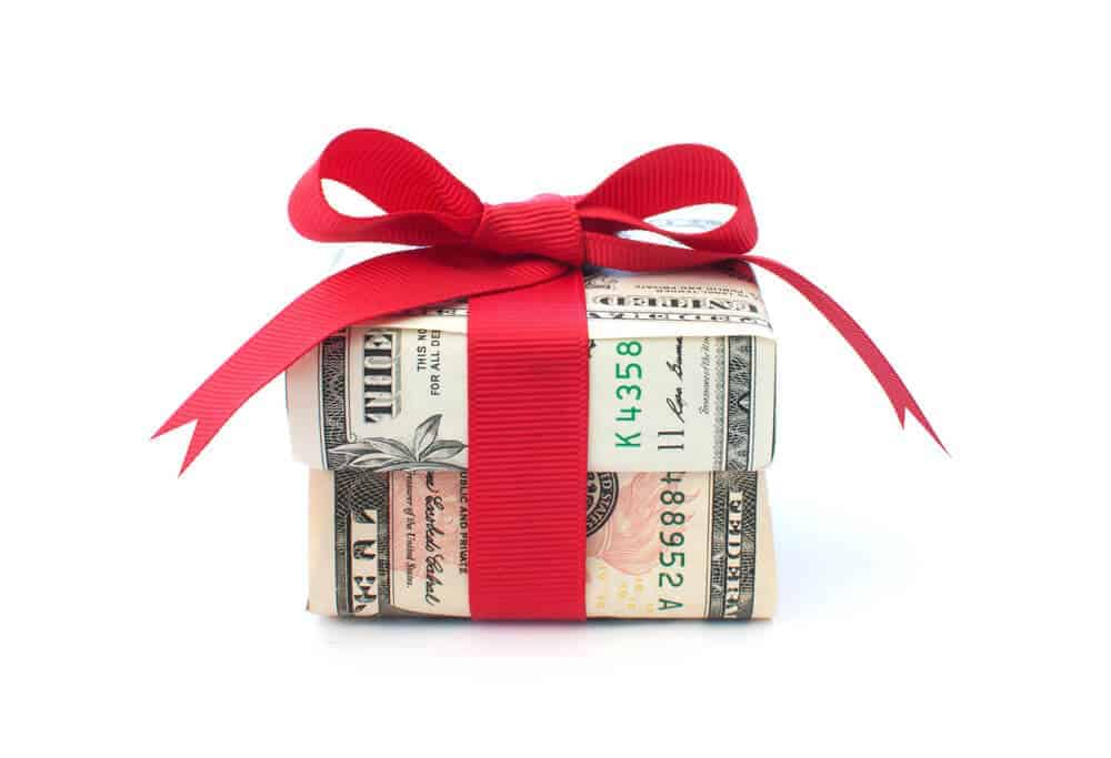 gift box made out of money with red bow
