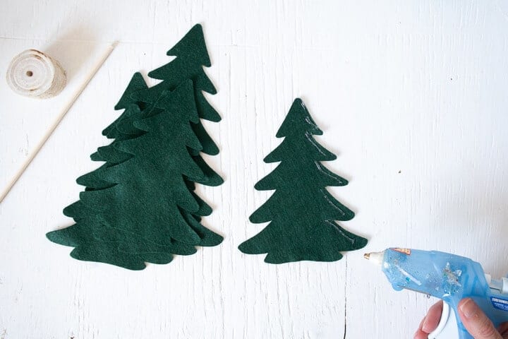 hot glue on the outer edge of one felt Christmas tree