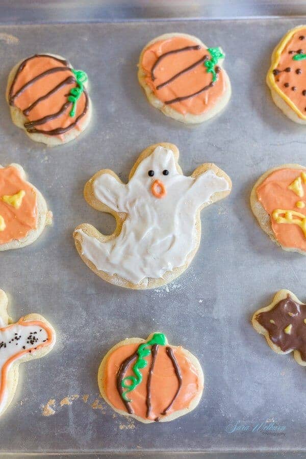 sugar cookies decorated like ghosts and pumpkins
