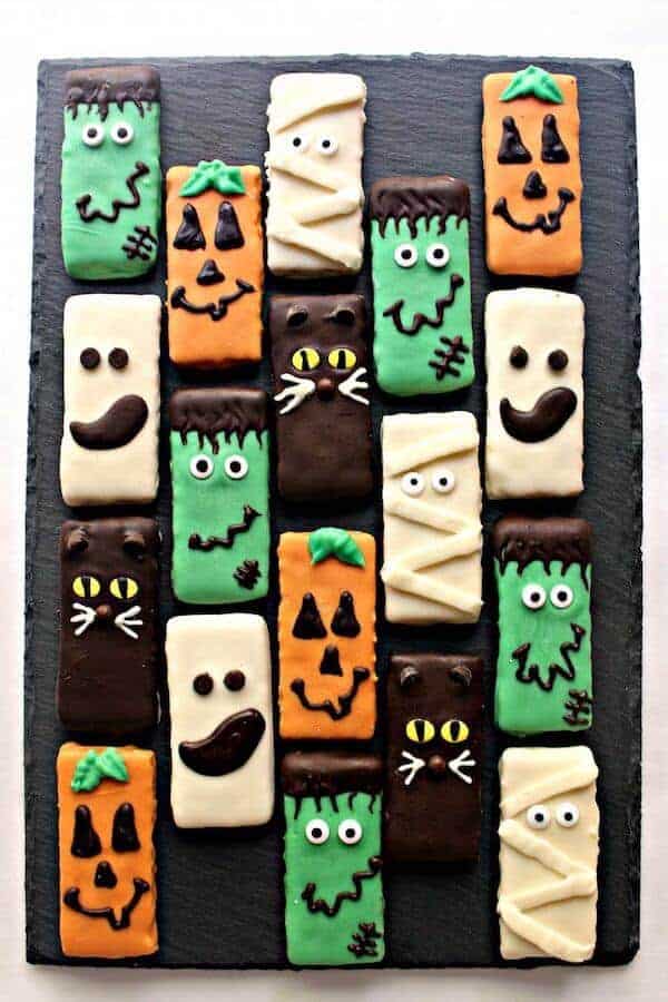 graham crackers decorated with colored melted chocolate for Halloween