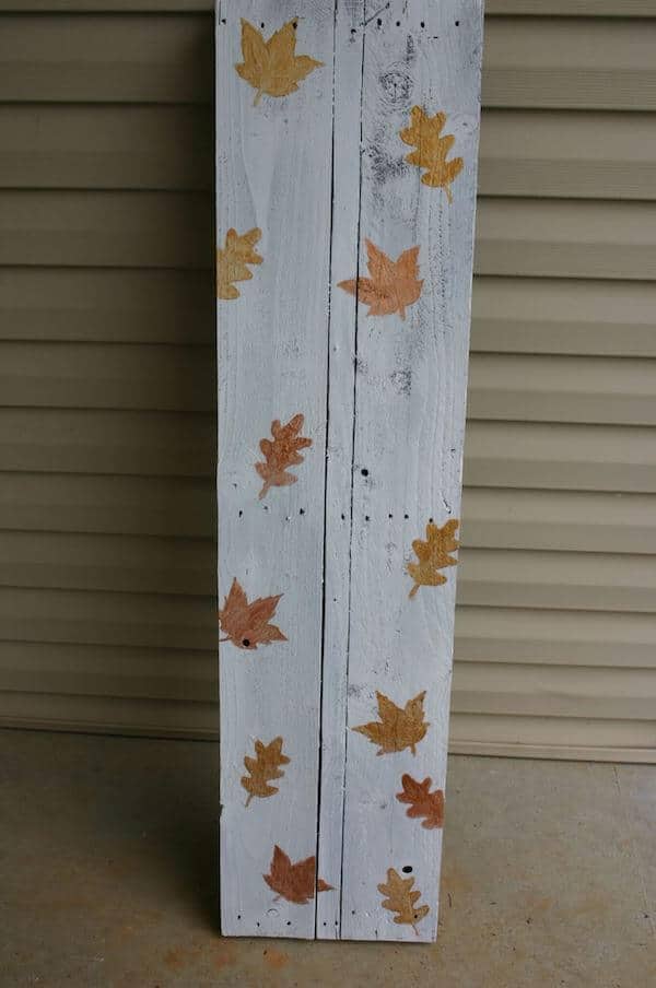 base of front porch fall sign painted white with metallic leaves