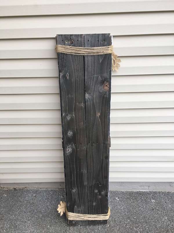 pallet wood nailed together to form a front porch sign