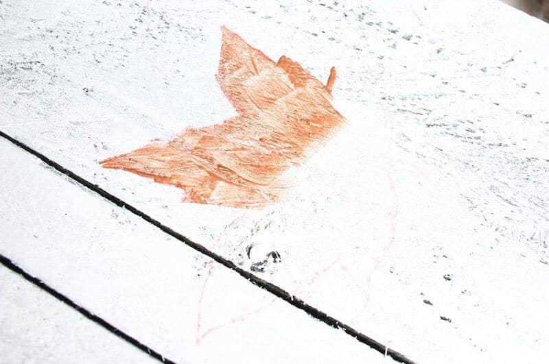 close up of leaf painting on the front porch fall sign