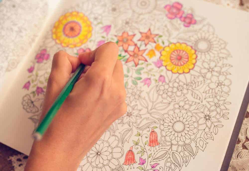 woman coloring in an adult coloring book