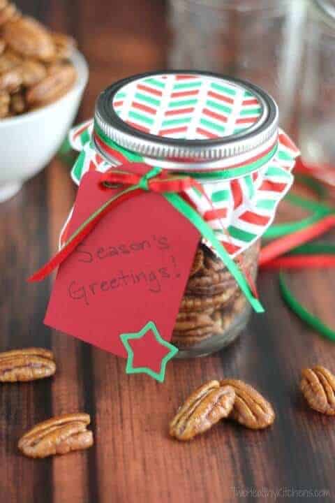 spiced pecans in a mason jar decorated for Christmas gifts