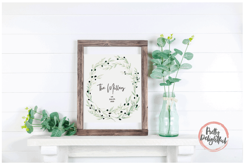 DIY personalized watercolor painting on a table with greenery