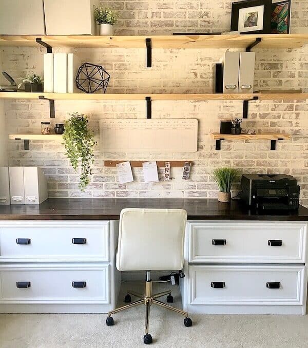 home office with a whitewashed brick accent wall