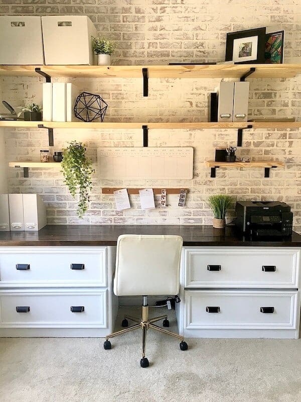 home office with a whitewashed brick accent wall