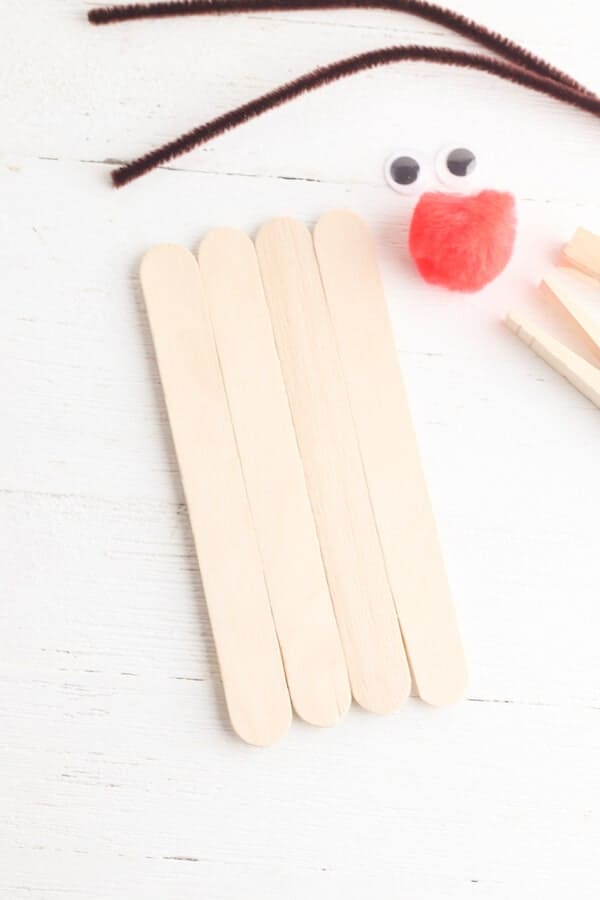 large popsicle sticks lined up on a table