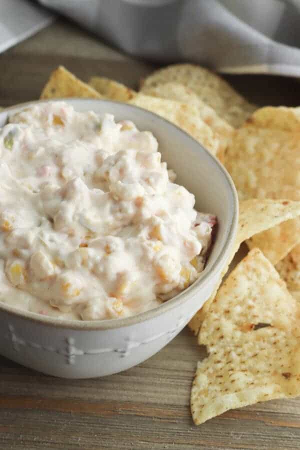 fiesta corn dip in a serving bowl with tortilla chips