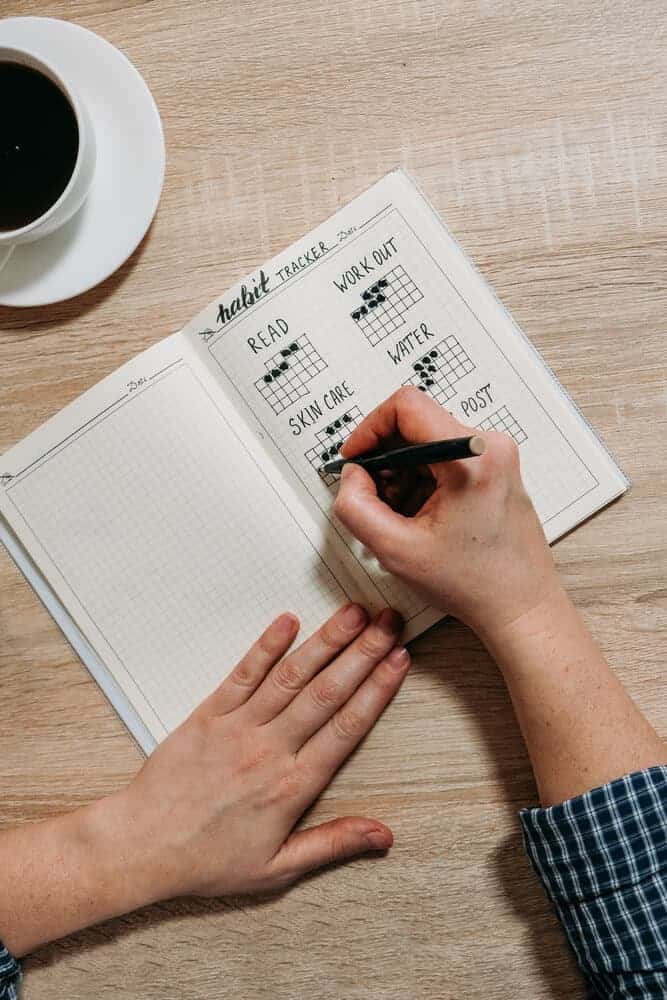 lady writing in a habit tracker