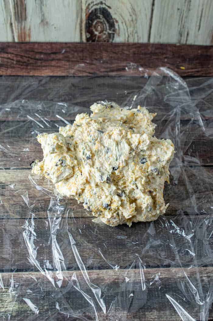 ranch olive cheeseball mixture on top of plastic wrap